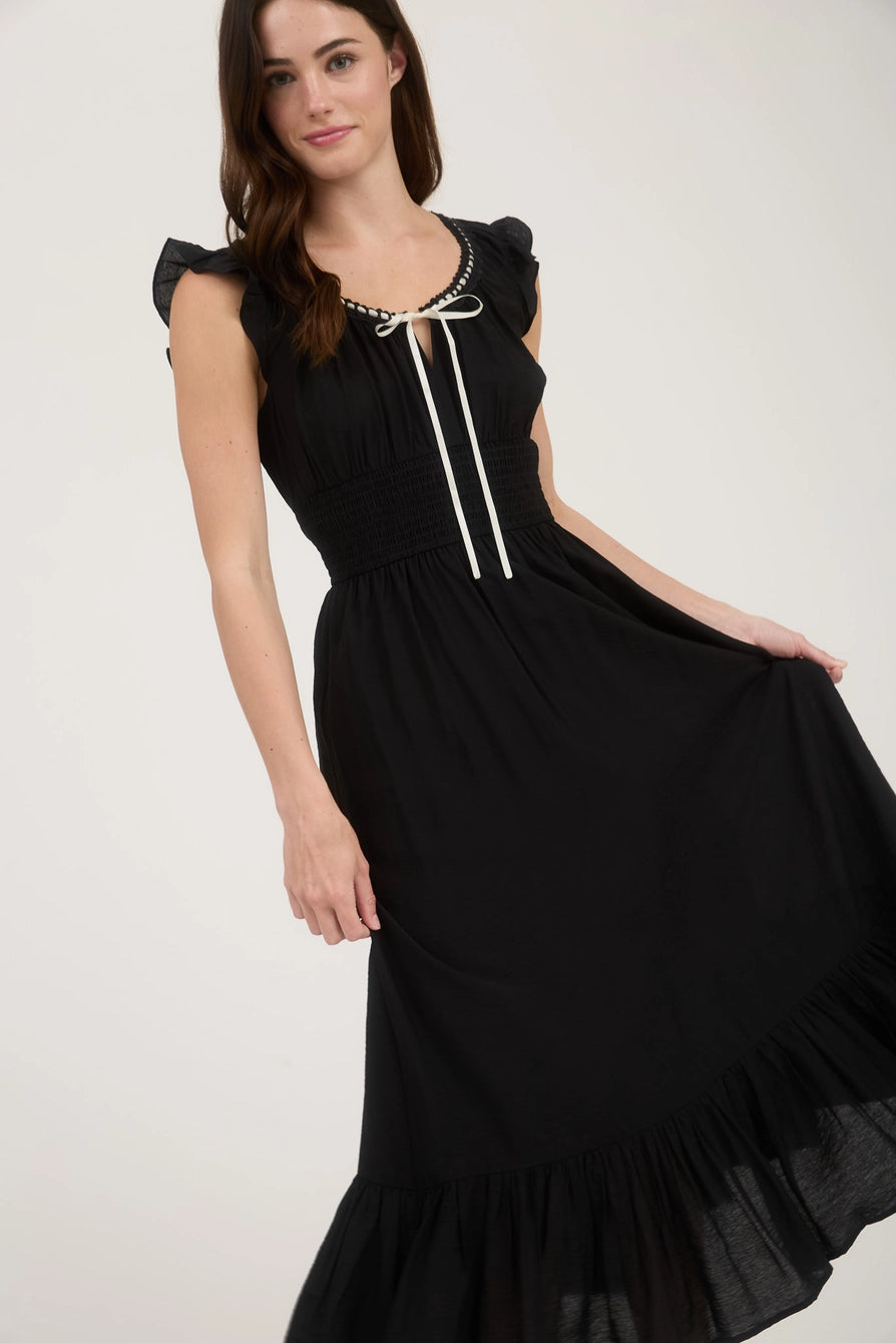 Elegant black dress with smocked waist and flutter sleeves – angled view