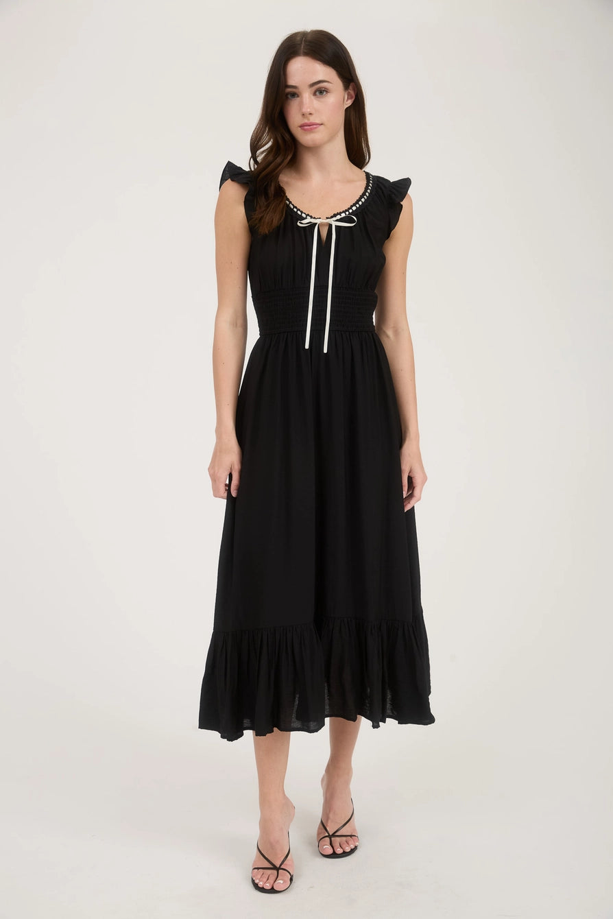 Black smocked waist midi dress with contrast ribbon tie and ruffle hem – front view